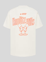 Weißes T-Shirt mit großem orangefarbenem Rückenstick „Kaulitz Hills est. 2021“ und Illustration von zwei Mikrofonen.